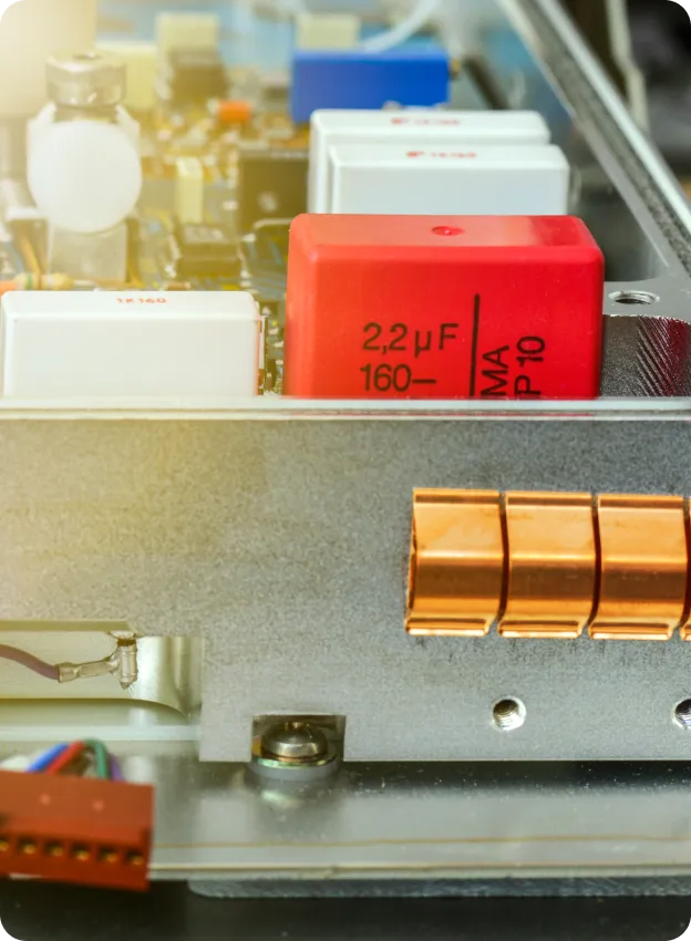 Red capacitor on circuit board.