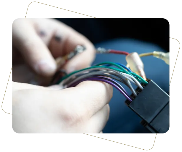 Hands wiring car stereo connector.